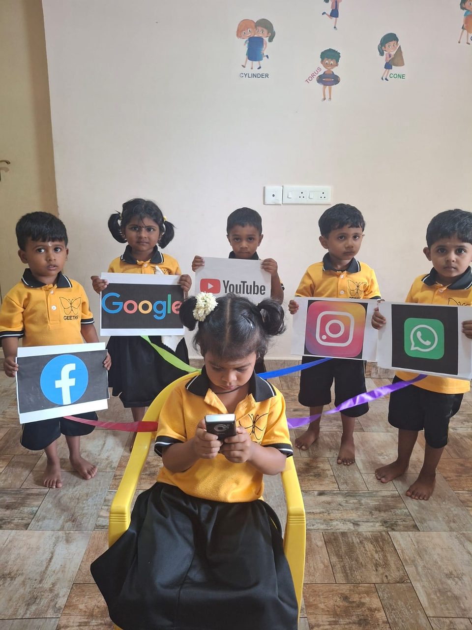 Children holding cards of social media and WhatsApp icons