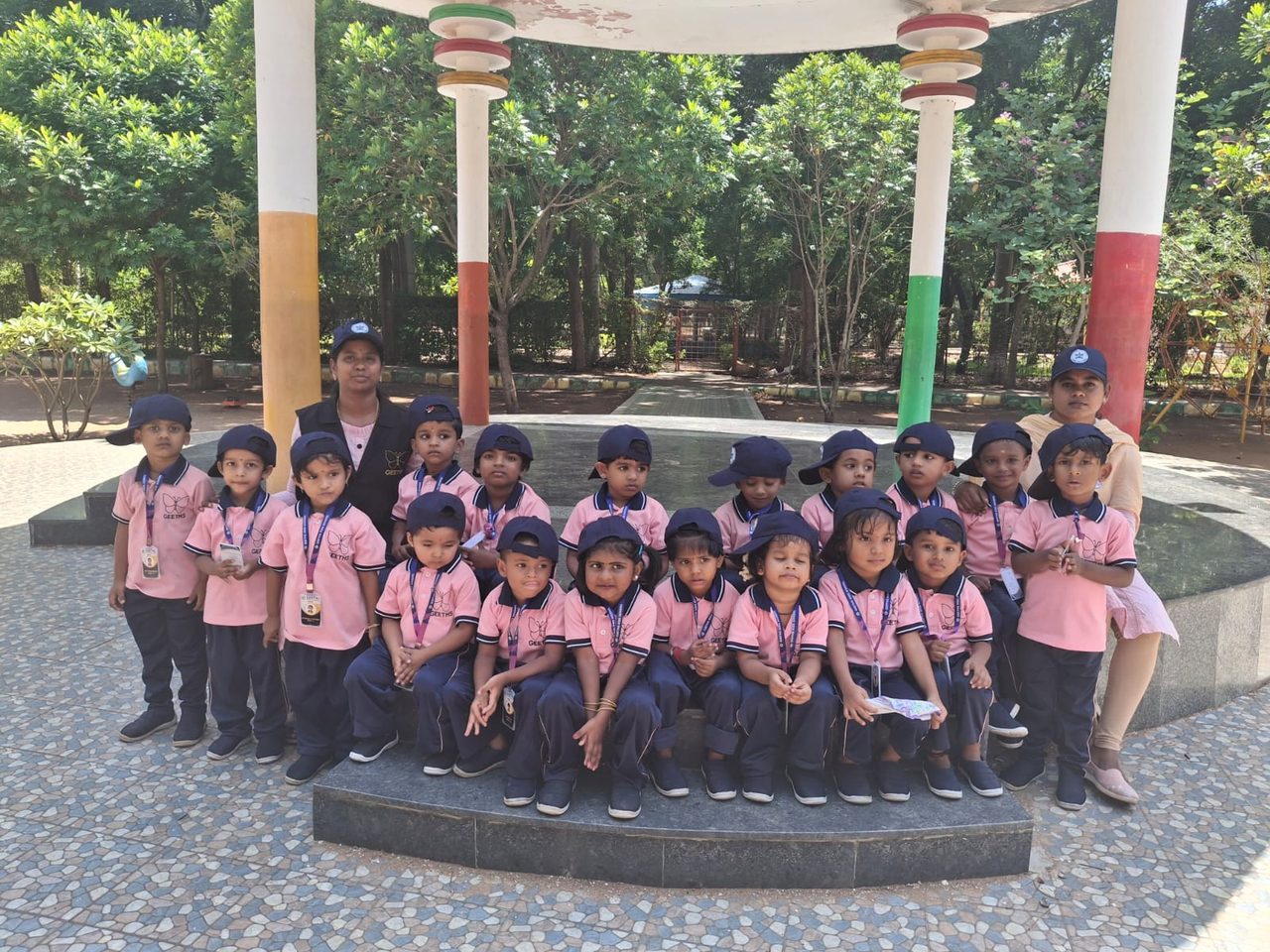 Children of Geeths Kids School in pink uniforms posing together